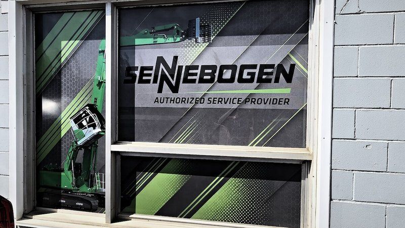 Sennebogen Authorized Service Provider window graphic on the Mach 6 building