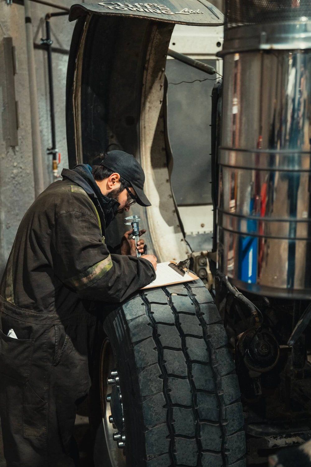 Mach 6 technician measuring a component and logging the finding during an inspection