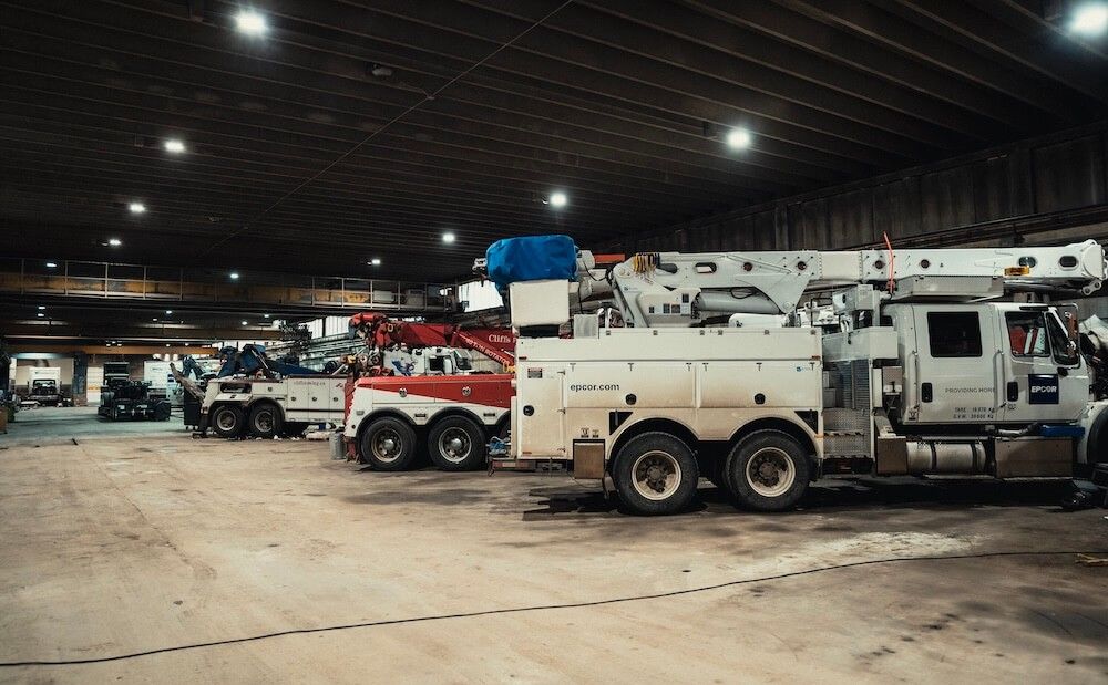 Cranes and vocational service trucks in the Mach 6 shop bay
